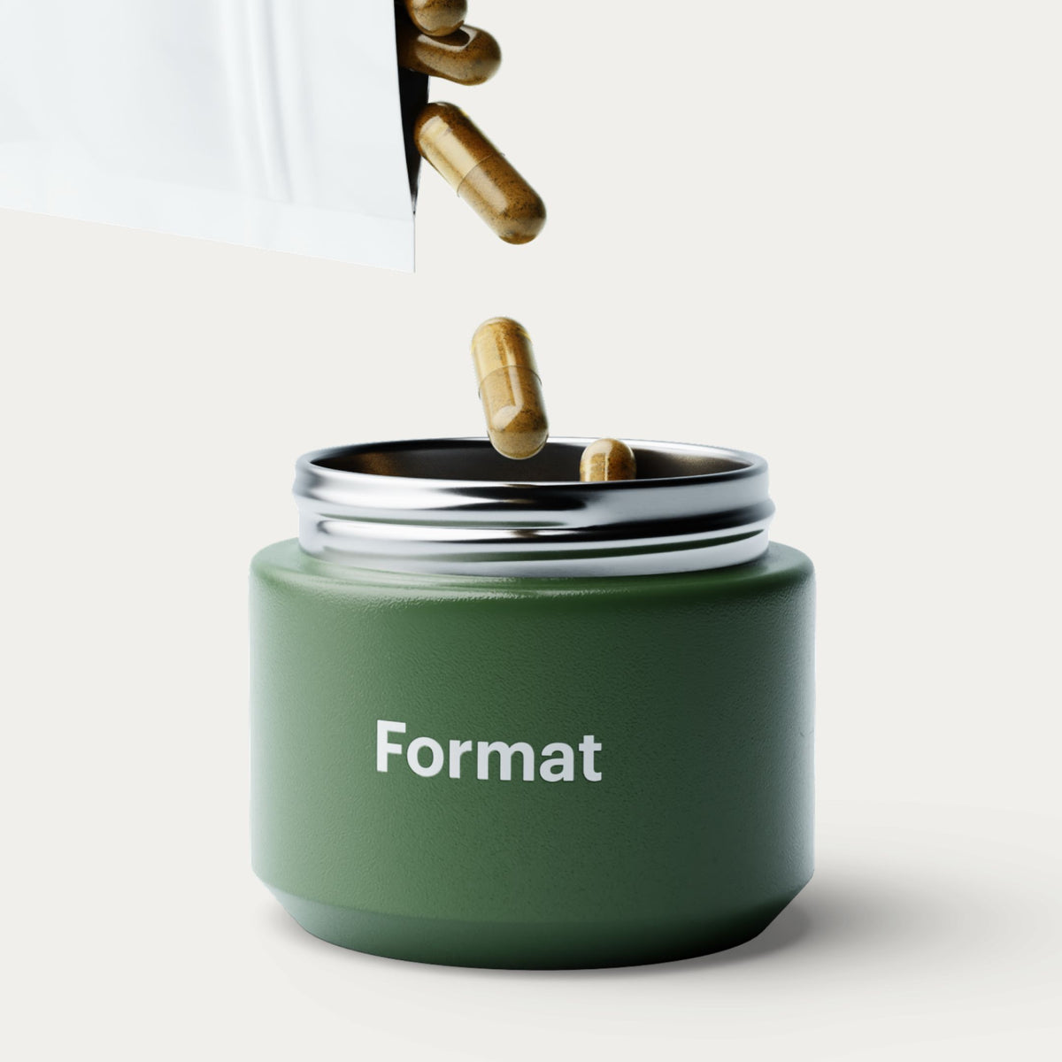 A matte dark green cylindrical container with a silver rim and the word 'Format' printed in white on the front. Gold capsules are shown falling into the open container from above against a clean off-white background.