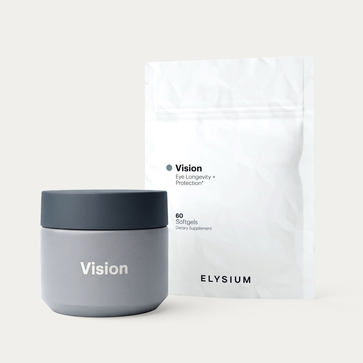 A gray jar with a dark gray lid labeled 'Vision' stands in front of a white stand-up pouch package printed with 'Vision Eye Longevity + Protection' and 'ELYSIUM' on a light beige studio background.
